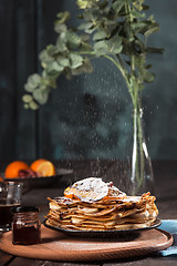 Image showing Fresh homemade french crepes made with eggs, milk and flour, filled with marmalade on a vintage plate