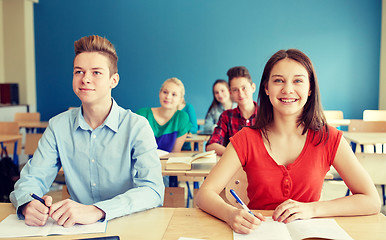 Image showing happy students with notebooks at school