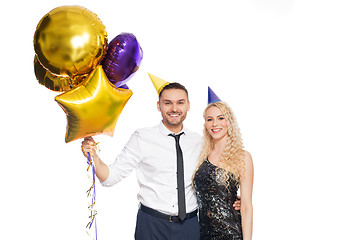 Image showing happy couple with party caps and balloons