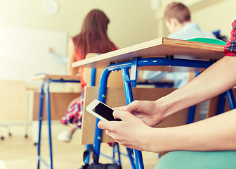 Image showing student boy with smartphone texting at school