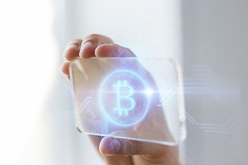 Image showing close up of bitcoin on transparent smartphone