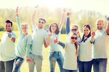 Image showing group of volunteers showing thumbs up in park