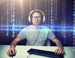 Image showing man in headset hacking computer or programming