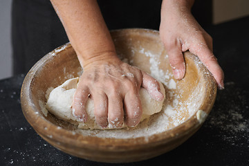 Image showing Baker hands kneading dough