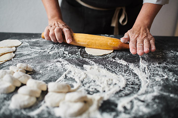 Image showing Woman rolling the dough by hands