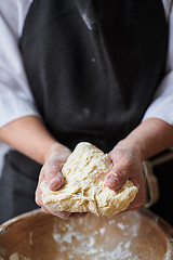 Image showing Baker hands kneading dough