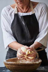 Image showing Baker hands kneading dough