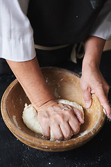 Image showing Baker hands kneading dough