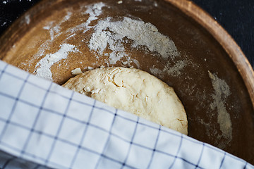 Image showing Dough in a wooden bowl