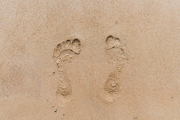 Image showing Footprints in the sand. Sandy beach on a Sunny summer day.