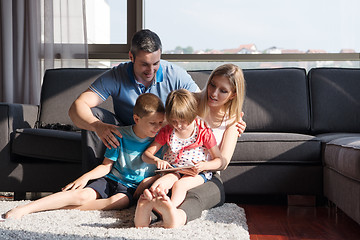 Image showing happy young couple spending time with kids