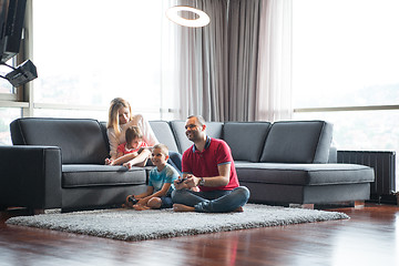 Image showing Happy family playing a video game