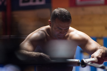 Image showing kick boxer resting on the ropes in the corner