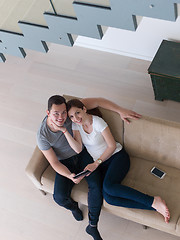 Image showing couple relaxing at  home with tablet computers