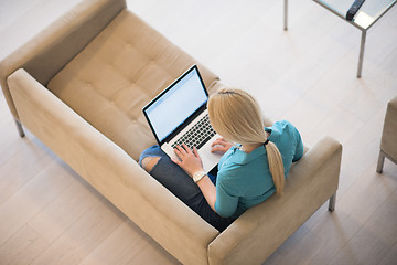 Image showing Young woman using laptop at home