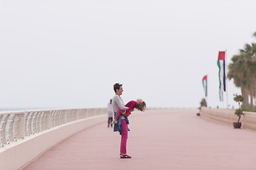 Image showing mother and cute little girl on the promenade by the sea