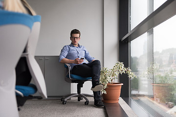 Image showing businessman in startup office by the window