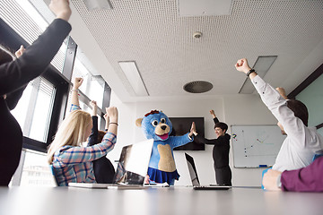 Image showing boss dresed as bear having fun with business people in trendy of