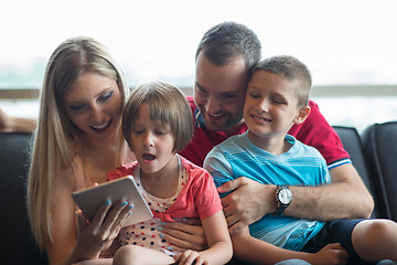 Image showing happy young couple spending time with kids