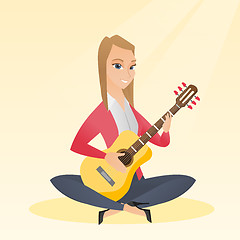 Image showing Woman playing the acoustic guitar.