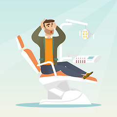 Image showing Afraid man sitting in the dental chair.
