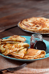 Image showing Fresh homemade french crepes made with eggs, milk and flour, filled with marmalade on a vintage plate