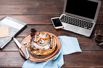 Image showing Laptop and pancakes with juice. Healthy breakfast