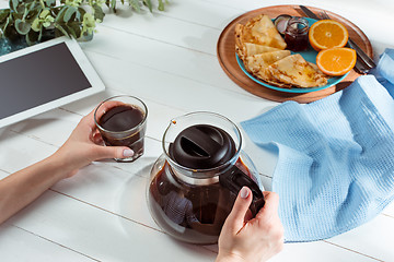 Image showing The female hands and pancakes with juice. Healthy breakfast