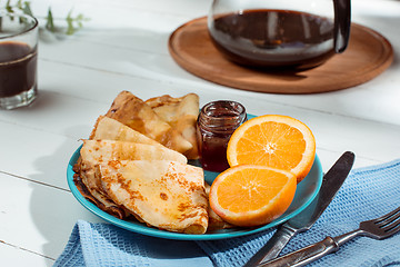 Image showing Fresh homemade french crepes made with eggs, milk and flour, filled with marmalade on a vintage plate