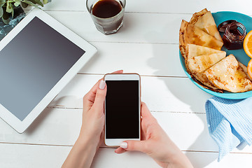 Image showing The female hands and pancakes with juice. Healthy breakfast