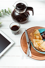 Image showing The tablet and pancakes with juice. Healthy breakfast