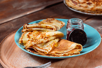 Image showing Fresh homemade french crepes made with eggs, milk and flour, filled with marmalade on a vintage plate