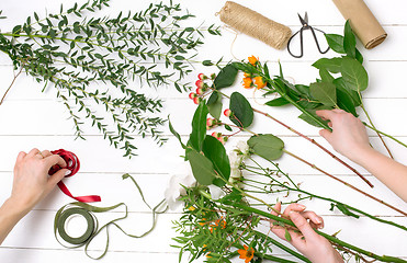 Image showing Female florist making beautiful bouquet at flower shop