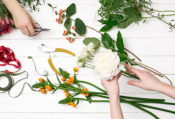 Image showing Female florist making beautiful bouquet at flower shop