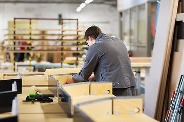 Image showing assembler making furniture factory workshop