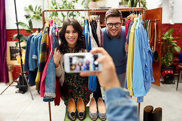 Image showing friend photographing couple at clothing store