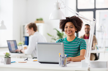 Image showing happy african woman with laptop computer at office