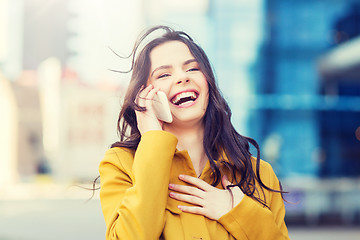 Image showing smiling young woman or girl calling on smartphone