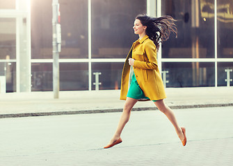 Image showing happy young woman or teenage girl on city street