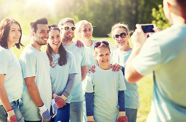 Image showing group of volunteers taking picture by smartphone