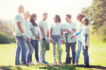 Image showing group of volunteers planting tree in park