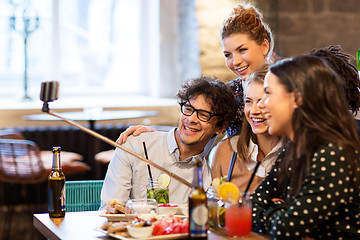 Image showing friends taking selfie by smartphone at bar or cafe