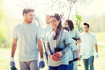 Image showing group of volunteers with trees and rake in park