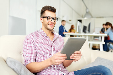 Image showing man in glasses with tablet pc working at office