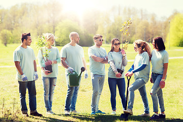 Image showing group of volunteers with trees and rake in park