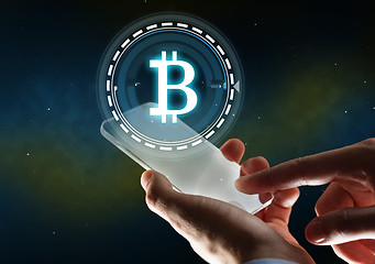 Image showing businessman with tablet pc and bitcoin hologram