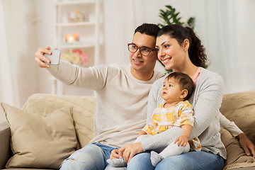 Image showing mother and father with baby taking selfie at home