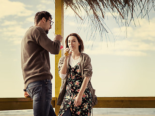 Image showing young couple drinking beer together at the beach