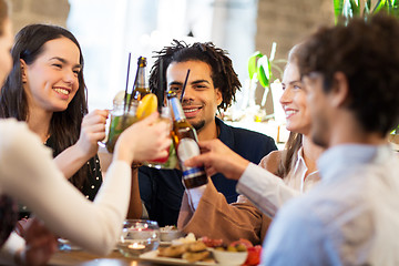 Image showing happy friends clinking drinks at bar