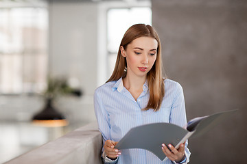 Image showing female office worker with folder